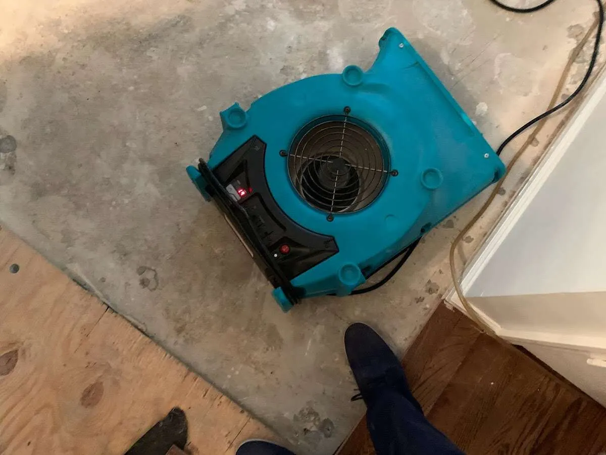 Air mover drying subfloor during Leak Detection & Repair in Crossville